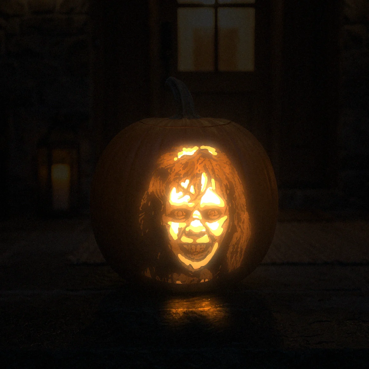 The Exorcist carved into a pumpkin and lit on a doorstep at night