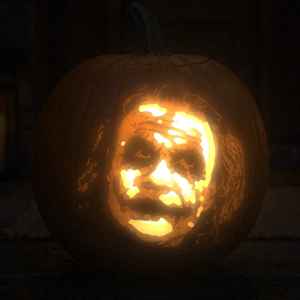 The Joker carved into a glowing pumpkin